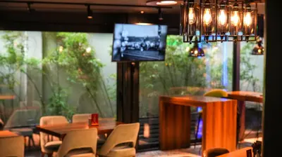 a dining room with a table and chairs and a television at Milord Hotel in Istanbul