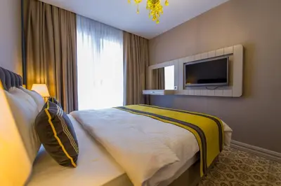 a hotel room with a bed and a flat screen tv at Homelike Hotel in Istanbul