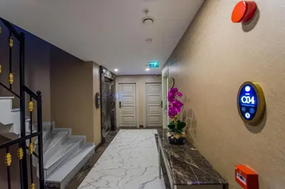 a hallway of a hotel with a sign on the wall at Homelike Hotel in Istanbul