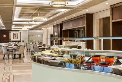 a restaurant with a buffet line with food on display at Elite World Grand Istanbul Basın Ekspres in Istanbul