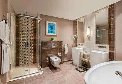a bathroom with a toilet and a shower and a sink at Elite World Grand Istanbul Basın Ekspres in Istanbul