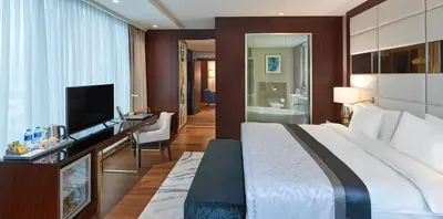 a hotel room with a large bed and a television at Elite World Grand Istanbul Basın Ekspres in Istanbul