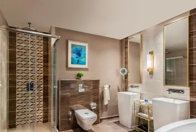 a bathroom with a toilet and a glass shower at Elite World Grand Istanbul Basın Ekspres in Istanbul