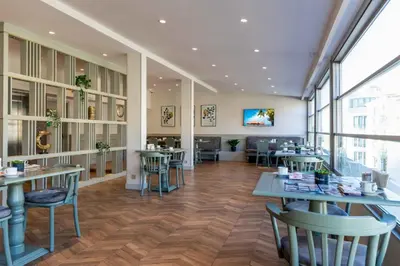 a restaurant with tables and chairs in a room at Hotel Genova Istanbul Old City in Istanbul