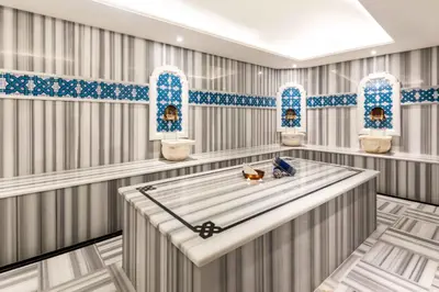 a tub in a room with blue and white tiles at Hotel Genova Istanbul Old City in Istanbul