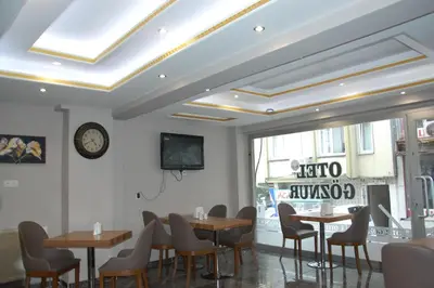 a dining room with tables and chairs and a window at Göznur Otel in Bandırma