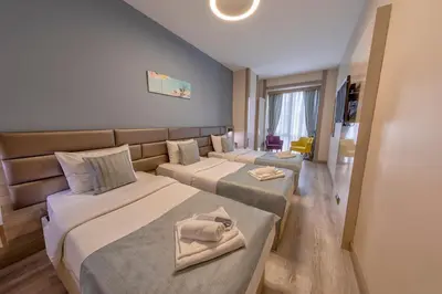 a hotel room with two beds with towels on them at My House N5 Suites Hotel in Esenyurt
