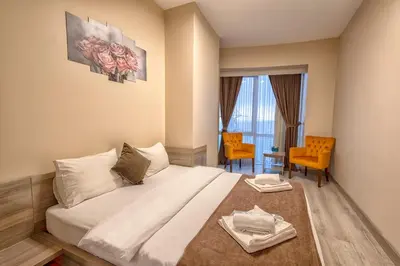 a hotel room with a bed and a table and chairs at My House N5 Suites Hotel in Esenyurt