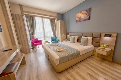 a hotel room with a bed and a table and chairs at My House N5 Suites Hotel in Esenyurt