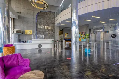 a large room with a purple chair and a table at My House N5 Suites Hotel in Esenyurt