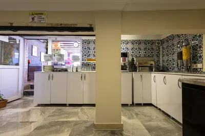 a kitchen with white cabinets and a pillar at Sultanahmet inn Hotel in Istanbul