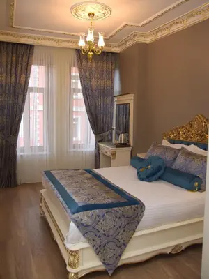 a bedroom with a king sized bed with a chandelier at İstasyon Hotel in Istanbul