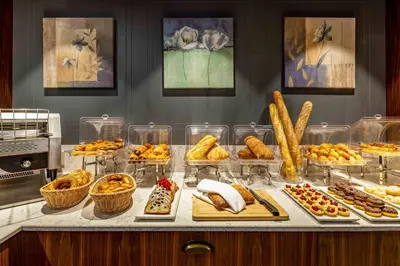 a buffet with many different types of food on a counter at Tzl Suites Hotel Nişantaşı in Istanbul