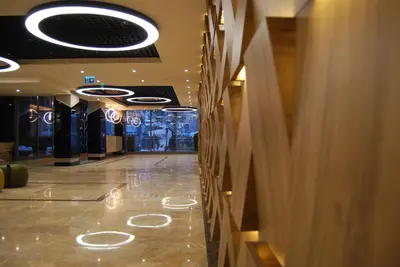 a hallway of a building with lights on the floor at The City Suites in Istanbul