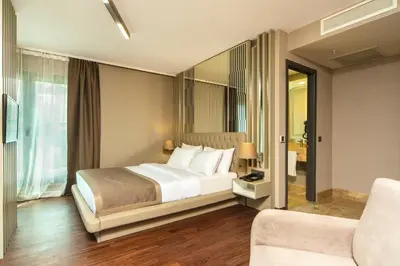 a hotel room with a bed and a chair at The City Suites in Istanbul