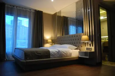 a bedroom with a large bed with a large window at The City Suites in Istanbul