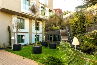 a courtyard with trees and plants in a building at The City Suites in Istanbul