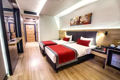 a hotel room with two beds and a television at Ramada Encore by Wyndham Gebze in Gebze