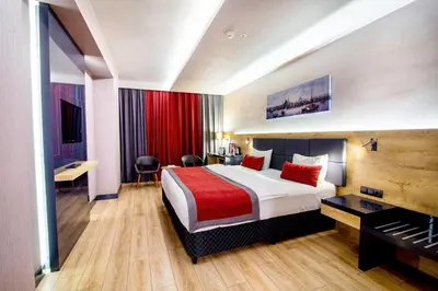 a hotel room with a bed and a piano at Ramada Encore by Wyndham Gebze in Gebze
