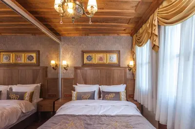 a bedroom with two beds and a chandelier at Ferman Konak Hotel-Special Category in Istanbul