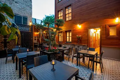 a patio with tables and chairs and a building at Ferman Konak Hotel-Special Category in Istanbul