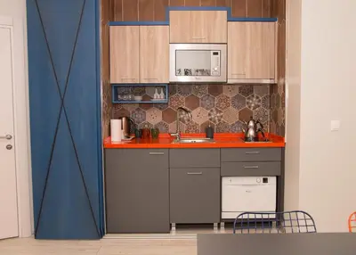 a kitchen with a sink and a microwave at Zin D Home Dudullu Otel in Istanbul