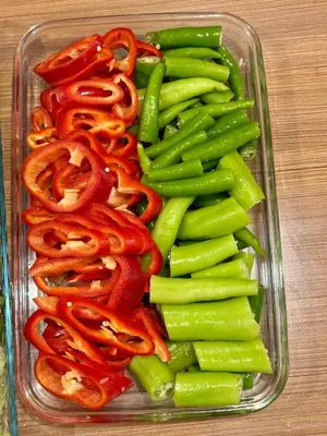 a glass container filled with peppers and green beans at Red White Hotel in Istanbul