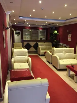 a waiting room with white couches and a red carpet at Red White Hotel in Istanbul