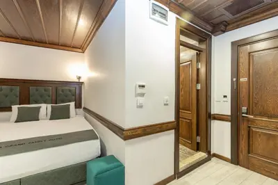 a bedroom with a bed and a wooden ceiling at Bursa Grand Family HOTEL in Bursa