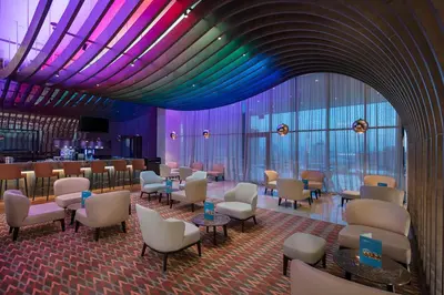 a waiting room with chairs and tables and purple lighting at Doubletree by Hilton Istanbul Umraniye in Istanbul