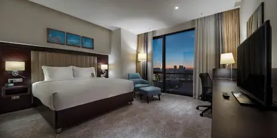 a hotel room with a bed and a television at Doubletree by Hilton Istanbul Umraniye in Istanbul