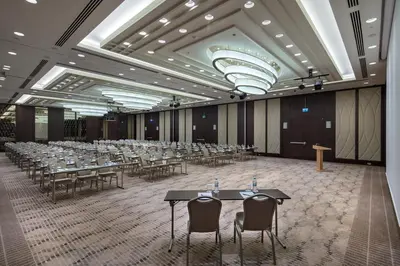 a banquet hall with tables and chairs and a podium at Doubletree by Hilton Istanbul Umraniye in Istanbul