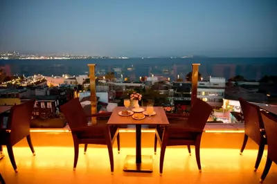 a table on a balcony with a view of a city at Ferman Hotel Old City -Special Category in Istanbul