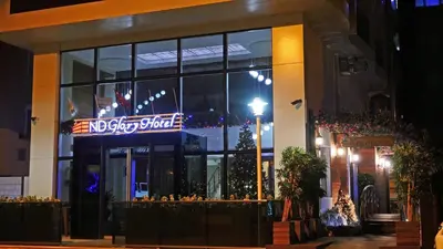 a building with a neon sign in front of it at Endglory Hotel in Corlu