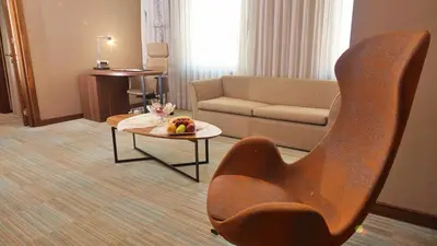 a living room with a couch and a chair and a table at Bricks Hotel İstanbul in Istanbul