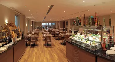 a restaurant with a buffet line with tables and chairs at Bricks Hotel İstanbul in Istanbul