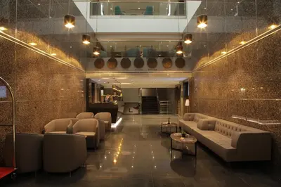 a lobby with couches and tables in a building at Bricks Hotel İstanbul in Istanbul