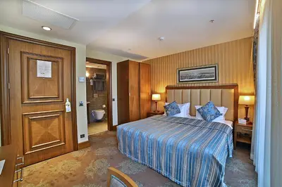 a hotel room with a bed and a bathroom at Adelmar Hotel Istanbul Sisli in Istanbul