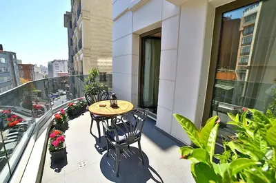 a table and chairs on the balcony of a building at Adelmar Hotel Istanbul Sisli in Istanbul