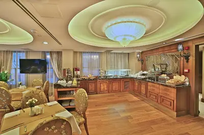 a living room with a table and a ceiling at Adelmar Hotel Istanbul Sisli in Istanbul