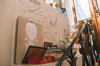 a wall with a picture of a man with writing on it at Green Life Apart Hotel in Istanbul