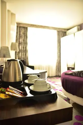 a hotel room with a tray of food on a table at Hande Hotel in Mustafakemalpaşa
