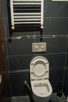 a small bathroom with a toilet and a window at Ömer Agah Istanbul Hotel Bayrampasa in Istanbul