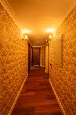 a hallway with yellow walls and wooden floors at Golden Dream Otel in Istanbul