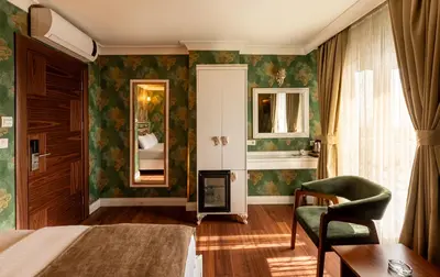 a hotel room with a bed and a chair at Golden Dream Otel in Istanbul