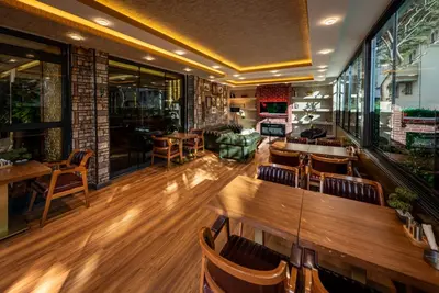 a restaurant with a bar with wooden tables and chairs at Golden Dream Otel in Istanbul