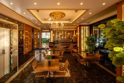 a restaurant with wooden tables and chairs and a chandelier at Golden Dream Otel in Istanbul