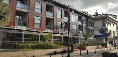 a building on a street with benches in front of it at The Elegant Hotel in Istanbul