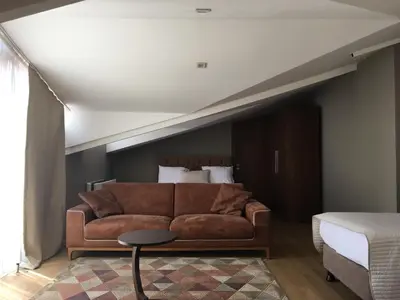 a living room with a couch and a bed at The Elegant Hotel in Istanbul