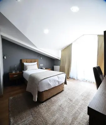 a bedroom with a large bed and a large window at The Elegant Hotel in Istanbul